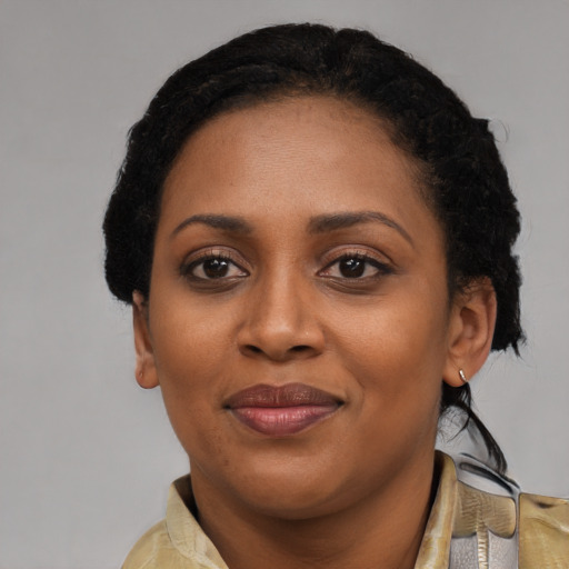 Joyful black young-adult female with short  black hair and brown eyes