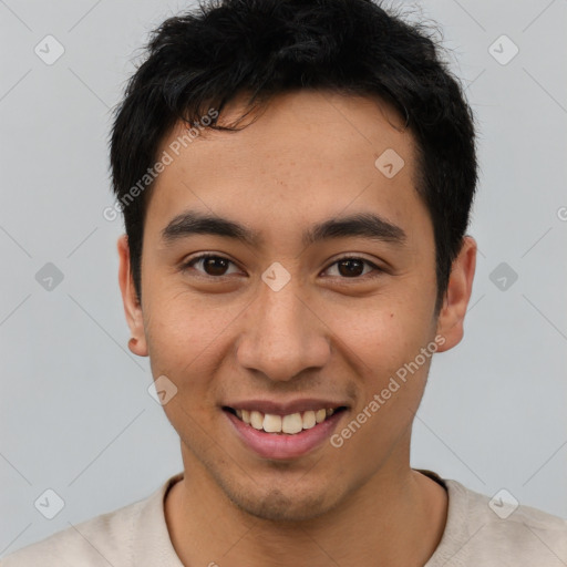 Joyful asian young-adult male with short  brown hair and brown eyes