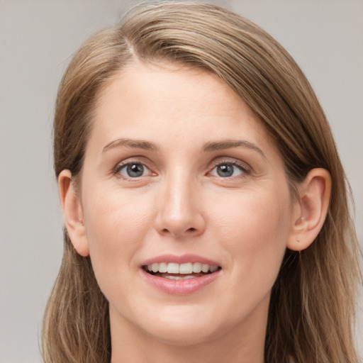 Joyful white young-adult female with long  brown hair and grey eyes