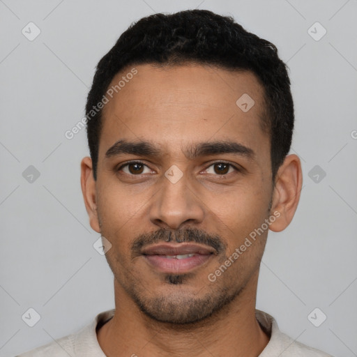 Joyful latino young-adult male with short  black hair and brown eyes