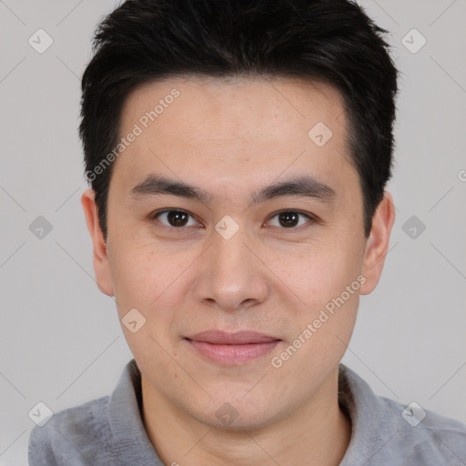 Joyful asian young-adult male with short  brown hair and brown eyes