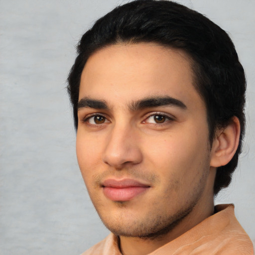 Joyful latino young-adult male with short  black hair and brown eyes