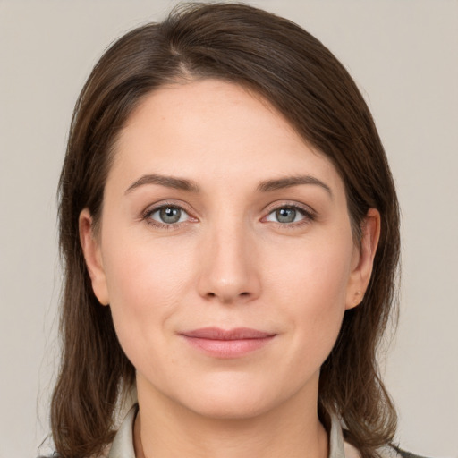 Joyful white young-adult female with medium  brown hair and grey eyes