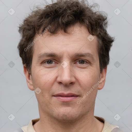 Joyful white adult male with short  brown hair and grey eyes