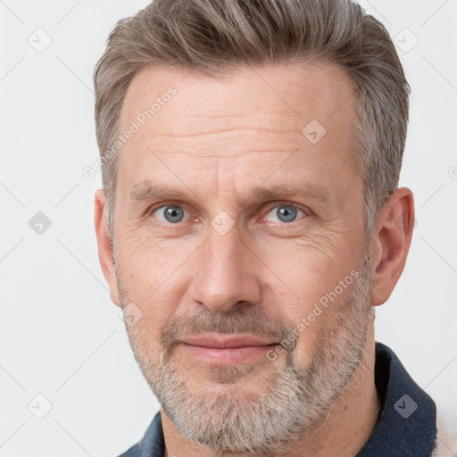 Joyful white adult male with short  brown hair and grey eyes