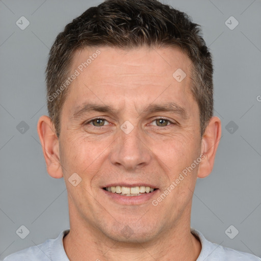 Joyful white adult male with short  brown hair and brown eyes