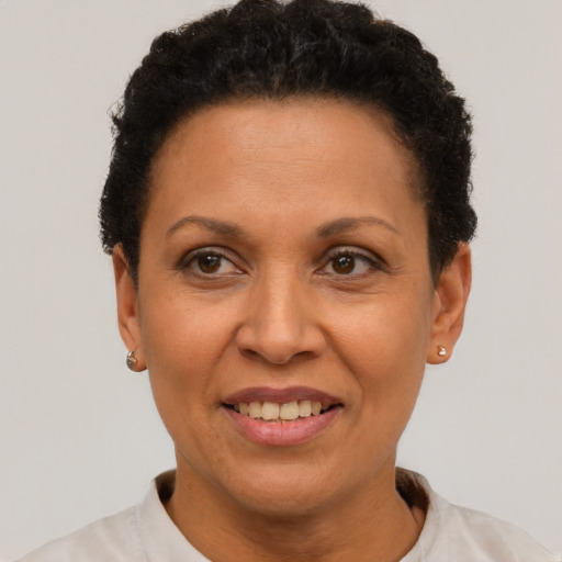 Joyful latino adult female with short  brown hair and brown eyes