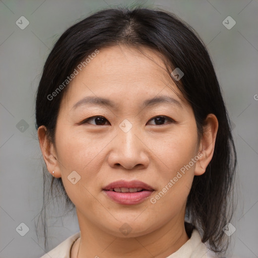 Joyful asian adult female with medium  brown hair and brown eyes