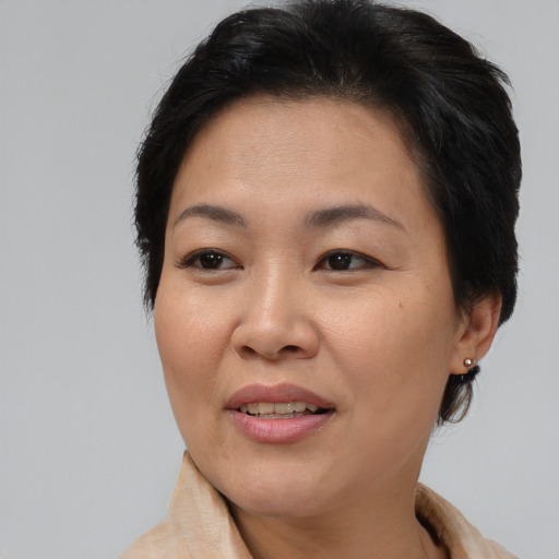 Joyful asian adult female with short  brown hair and brown eyes