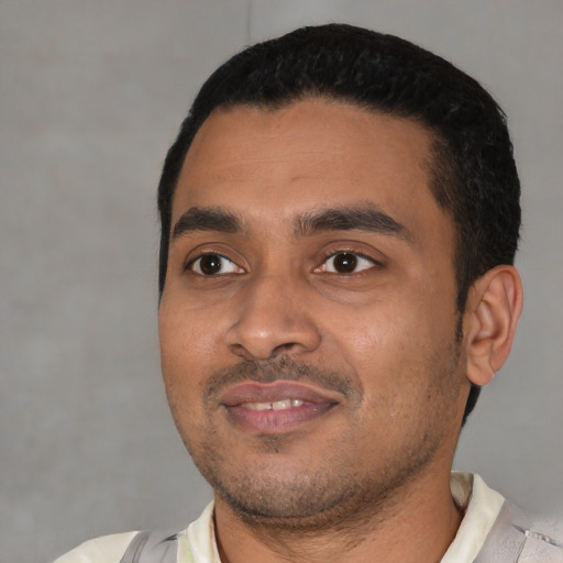 Joyful latino young-adult male with short  black hair and brown eyes