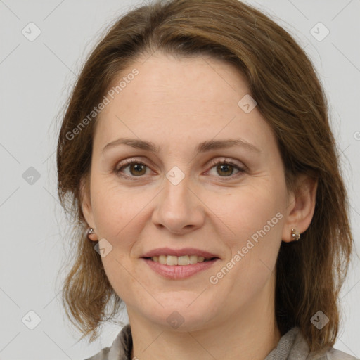 Joyful white adult female with medium  brown hair and grey eyes