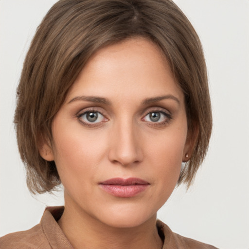 Joyful white young-adult female with medium  brown hair and grey eyes