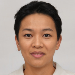 Joyful asian young-adult female with short  black hair and brown eyes