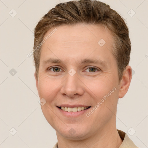 Joyful white young-adult male with short  brown hair and grey eyes