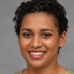 Joyful latino young-adult female with short  brown hair and brown eyes