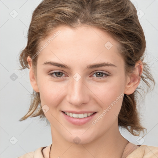 Joyful white young-adult female with medium  brown hair and grey eyes