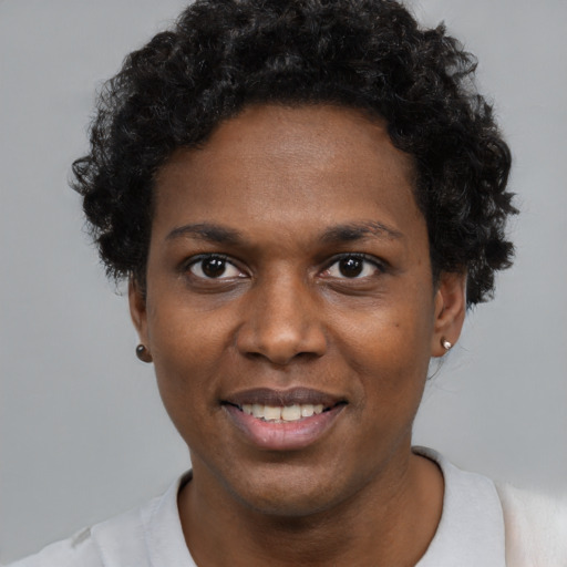 Joyful black adult female with short  black hair and brown eyes