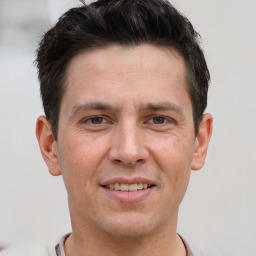 Joyful white adult male with short  brown hair and brown eyes