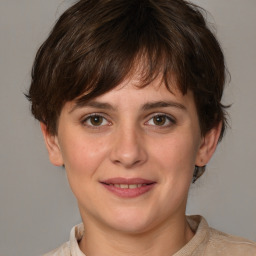 Joyful white young-adult female with medium  brown hair and grey eyes