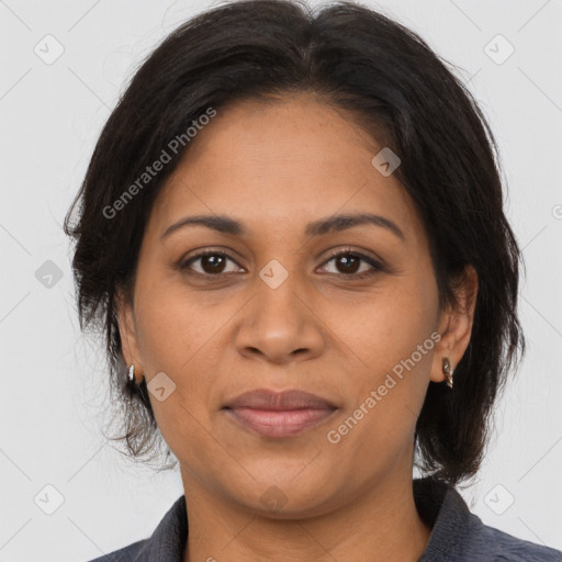 Joyful latino adult female with medium  brown hair and brown eyes