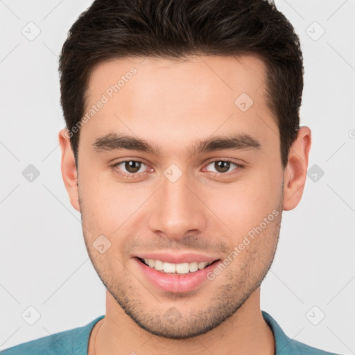 Joyful white young-adult male with short  brown hair and brown eyes