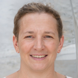 Joyful white adult female with short  brown hair and grey eyes