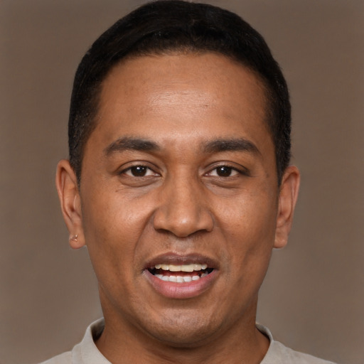 Joyful black adult male with short  black hair and brown eyes