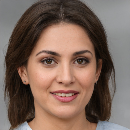 Joyful white young-adult female with medium  brown hair and brown eyes