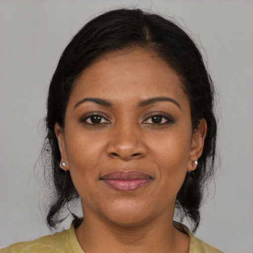 Joyful black adult female with medium  black hair and brown eyes