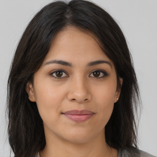 Joyful latino young-adult female with long  brown hair and brown eyes