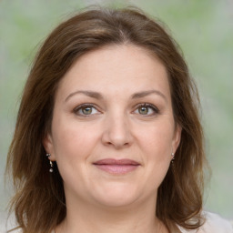 Joyful white young-adult female with medium  brown hair and green eyes