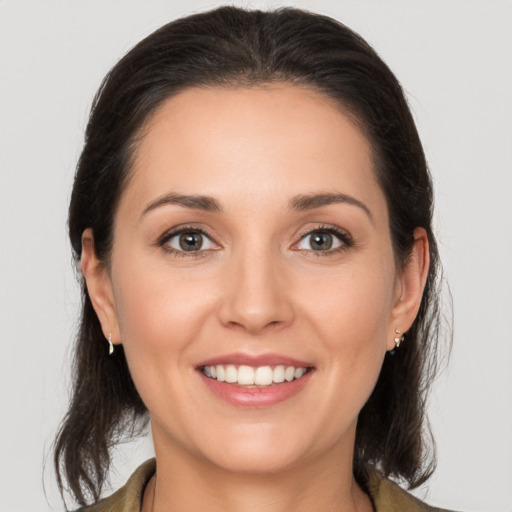 Joyful white young-adult female with medium  brown hair and brown eyes