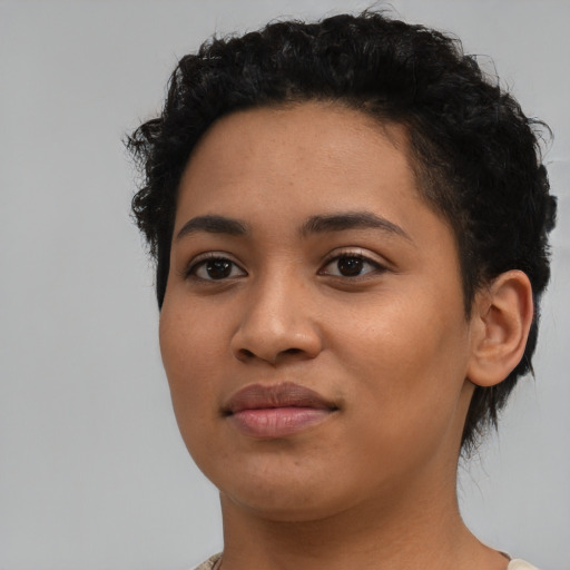 Joyful latino young-adult female with short  black hair and brown eyes