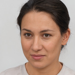 Joyful white adult female with medium  brown hair and brown eyes