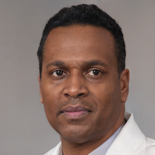 Neutral black adult male with short  black hair and brown eyes