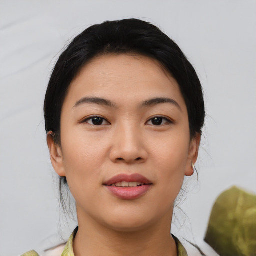 Joyful asian young-adult female with medium  black hair and brown eyes