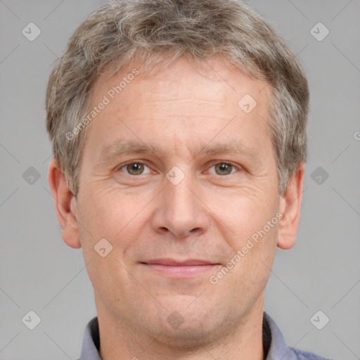 Joyful white adult male with short  brown hair and grey eyes