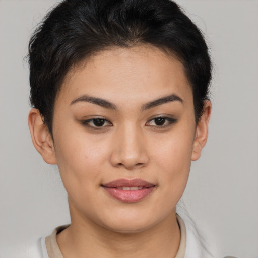 Joyful asian young-adult female with short  brown hair and brown eyes