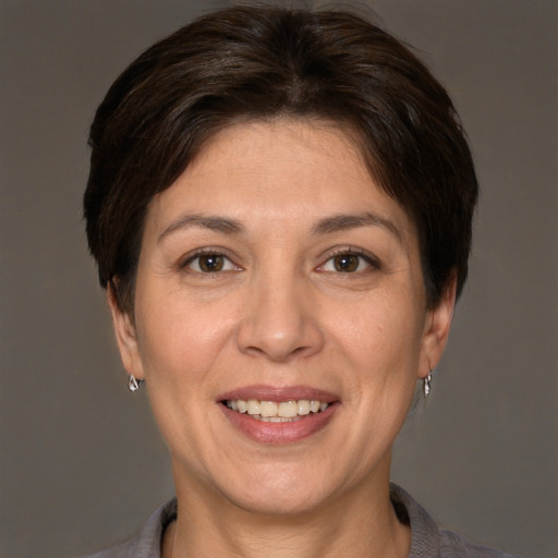 Joyful white adult female with short  brown hair and brown eyes