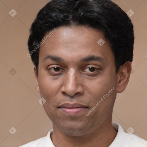 Joyful latino adult male with short  black hair and brown eyes