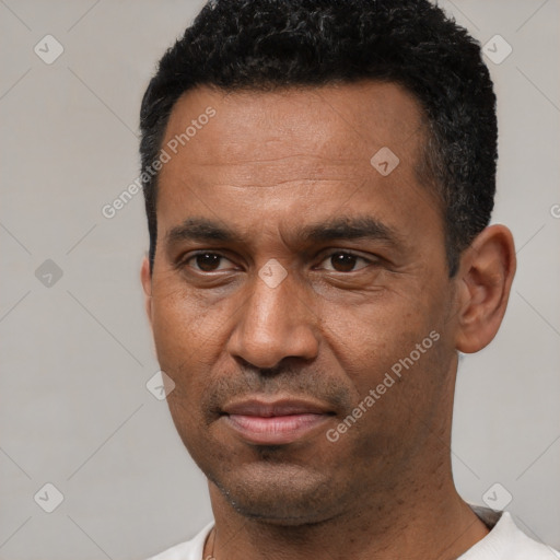 Joyful latino adult male with short  black hair and brown eyes