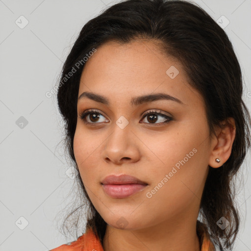 Joyful latino young-adult female with long  brown hair and brown eyes