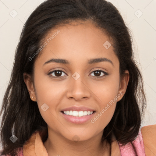 Joyful latino young-adult female with long  brown hair and brown eyes