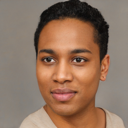 Joyful black young-adult male with short  black hair and brown eyes