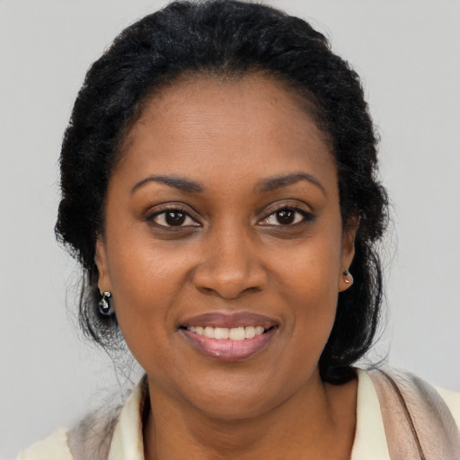 Joyful latino adult female with long  brown hair and brown eyes