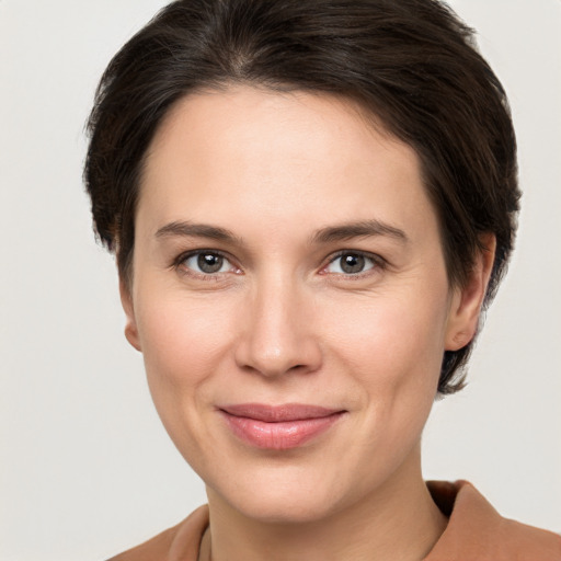 Joyful white young-adult female with medium  brown hair and brown eyes