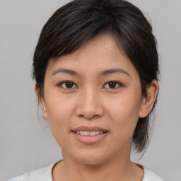 Joyful asian young-adult female with medium  brown hair and brown eyes