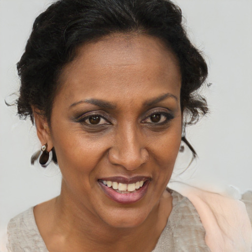 Joyful black adult female with short  brown hair and brown eyes