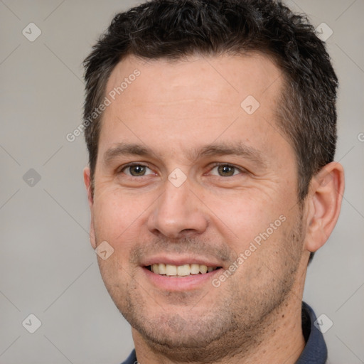 Joyful white adult male with short  brown hair and brown eyes