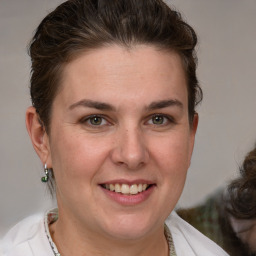 Joyful white adult female with medium  brown hair and brown eyes